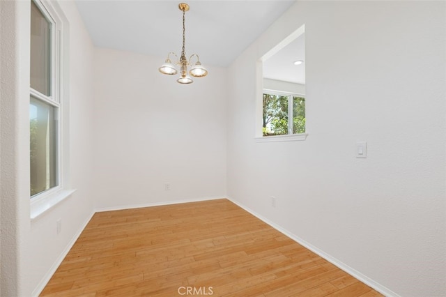 8542 E Heatherview Ln, Orange, CA 92869 - unfurnished room with light wood-type flooring and a chandelier