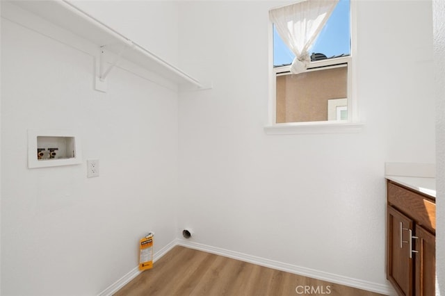 8542 E Heatherview Ln, Orange, CA 92869 - washroom featuring hookup for a washing machine, light wood-style floors, baseboards, and cabinet space