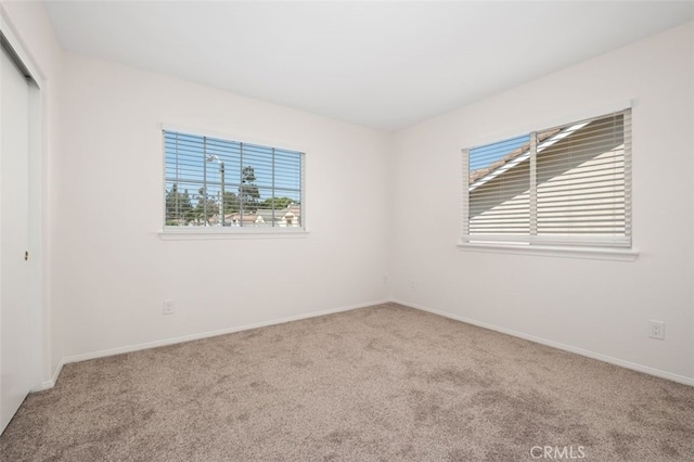 8542 E Heatherview Ln, Orange, CA 92869 - unfurnished bedroom featuring carpet floors, a closet, and multiple windows