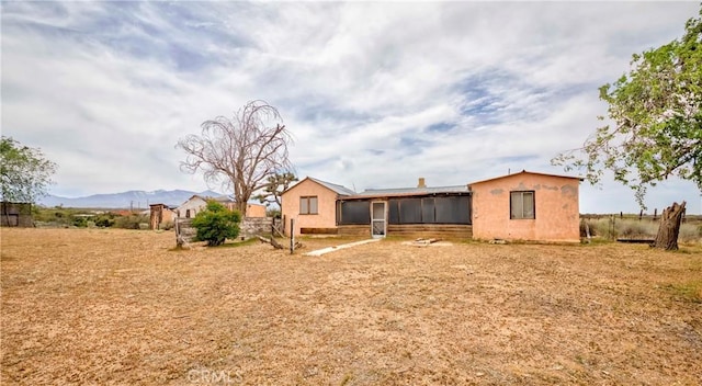 8288 White Rd, Phelan, CA 92371 - rear view of house with a sunroom and a mountain view