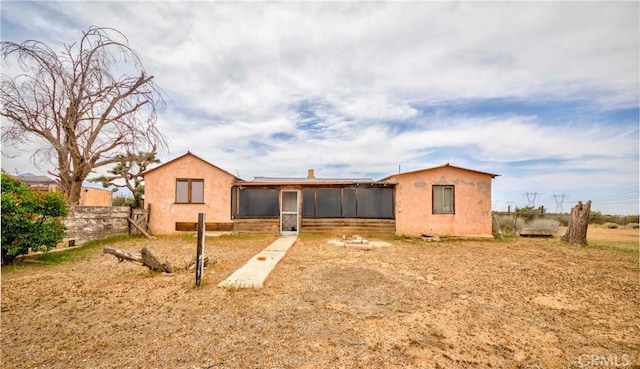 8288 White Rd, Phelan, CA 92371 - rear view of house with a sunroom, fence, and stucco siding