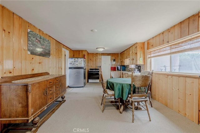 8288 White Rd, Phelan, CA 92371 - dining space featuring wood walls and light carpet