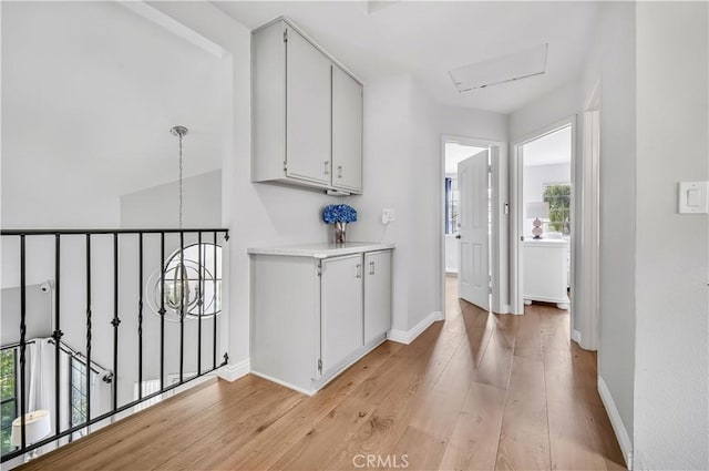 4017 Cottonwood Grove Trl, Calabasas, CA 91301 - hallway with light wood finished floors, baseboards, and a chandelier