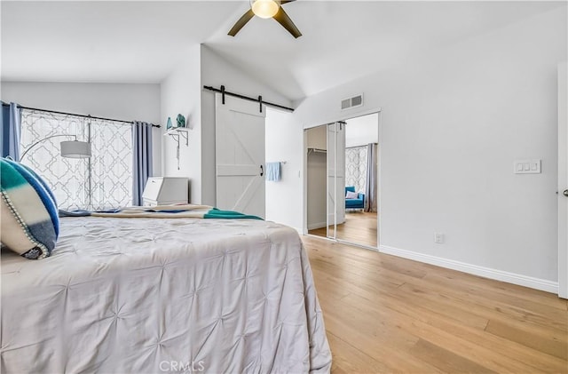 4017 Cottonwood Grove Trl, Calabasas, CA 91301 - bedroom with vaulted ceiling, a barn door, light wood finished floors, baseboards, and ceiling fan