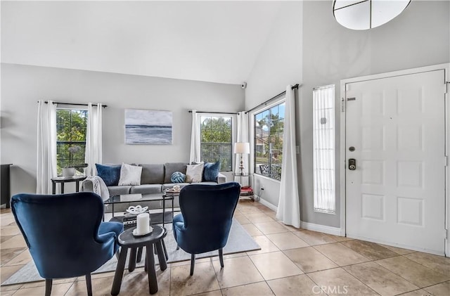 4017 Cottonwood Grove Trl, Calabasas, CA 91301 - entrance foyer featuring high vaulted ceiling, light tile patterned floors, and baseboards