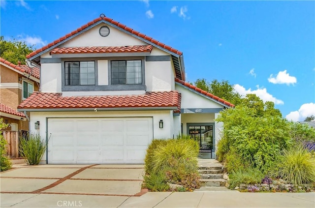 4017 Cottonwood Grove Trl, Calabasas, CA 91301 - mediterranean / spanish-style house featuring a tile roof, driveway, stucco siding, and an attached garage