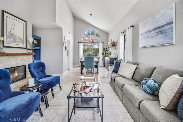 4017 Cottonwood Grove Trl, Calabasas, CA 91301 - living room with a stone fireplace, baseboards, light tile patterned floors, and high vaulted ceiling
