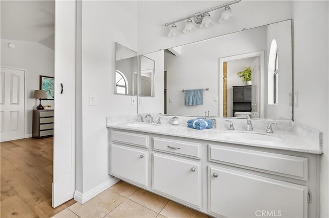 4017 Cottonwood Grove Trl, Calabasas, CA 91301 - full bath with double vanity, baseboards, vaulted ceiling, and tile patterned flooring