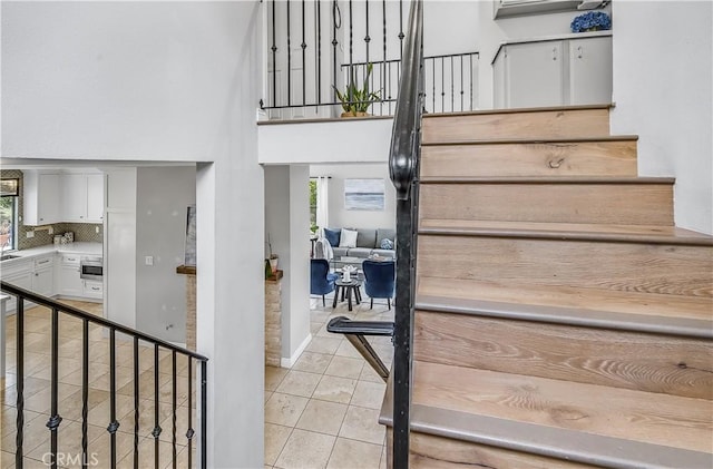 4017 Cottonwood Grove Trl, Calabasas, CA 91301 - stairs featuring tile patterned flooring and a towering ceiling