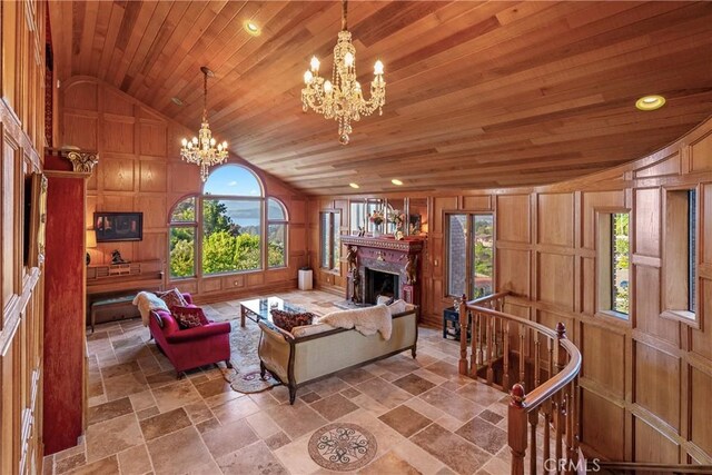 2743 Rodman Dr, Los Osos, CA 93402 - living area with a chandelier, wooden ceiling, stone tile floors, a fireplace, and a decorative wall