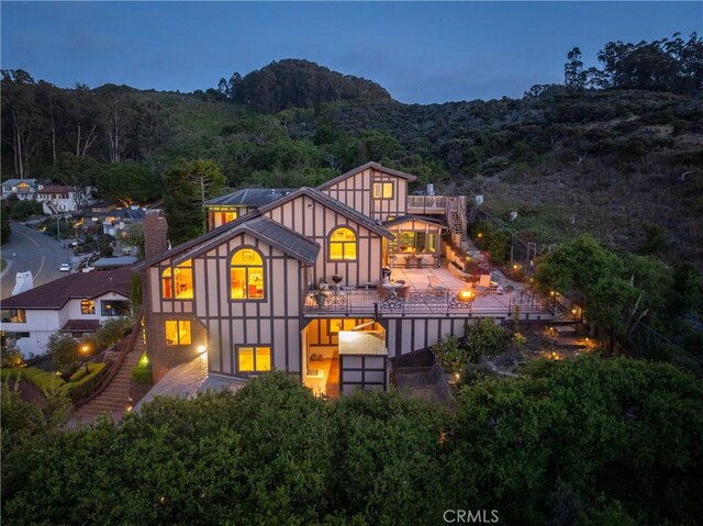2743 Rodman Dr, Los Osos, CA 93402 - back of house featuring a chimney, a forest view, and stairway