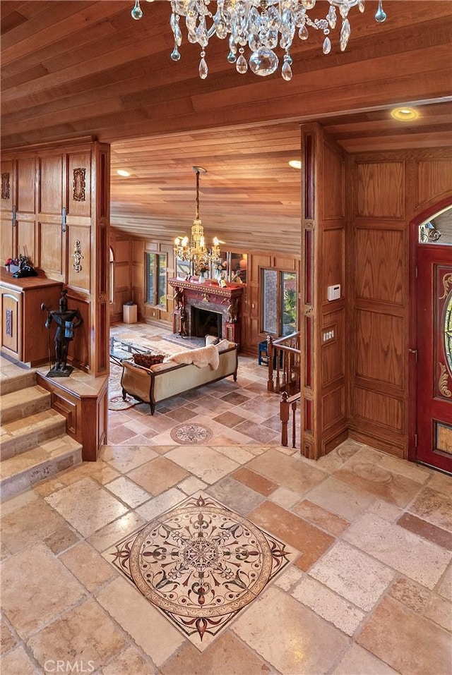 2743 Rodman Dr, Los Osos, CA 93402 - foyer entrance with a chandelier, stone tile floors, wood ceiling, recessed lighting, and a fireplace