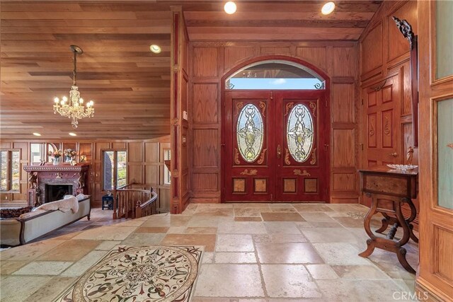 2743 Rodman Dr, Los Osos, CA 93402 - entrance foyer with stone tile flooring, wood ceiling, a chandelier, recessed lighting, and a fireplace