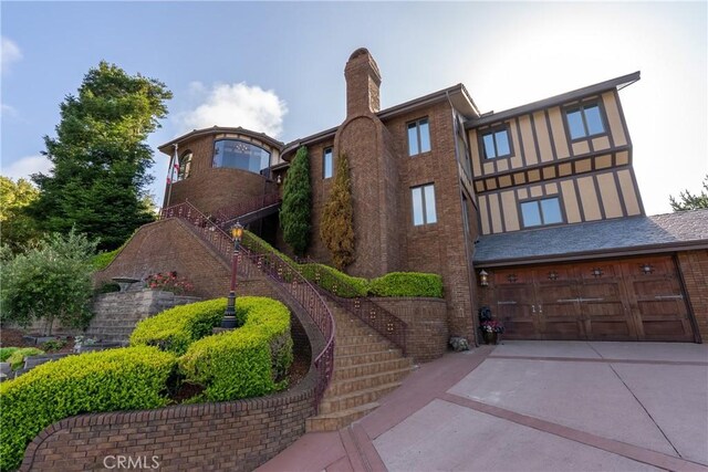 2743 Rodman Dr, Los Osos, CA 93402 - view of building exterior featuring stairway, an attached garage, and driveway