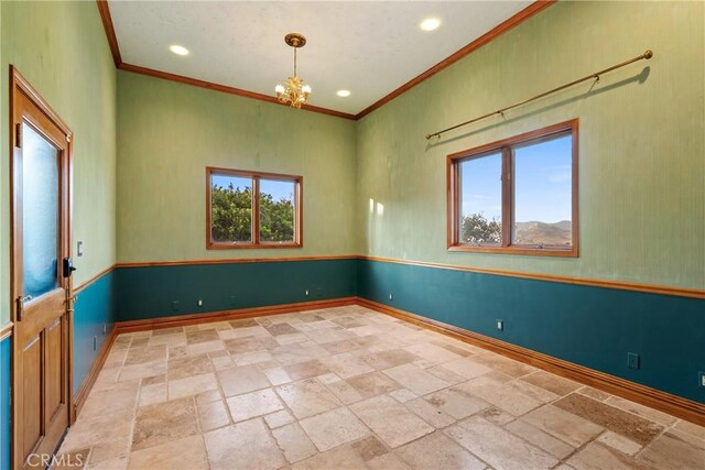 2743 Rodman Dr, Los Osos, CA 93402 - empty room featuring plenty of natural light, stone tile flooring, ornamental molding, a chandelier, and baseboards