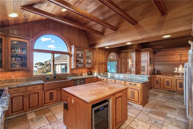 2743 Rodman Dr, Los Osos, CA 93402 - kitchen featuring wood ceiling, a sink, butcher block countertops, stone tile flooring, and a center island
