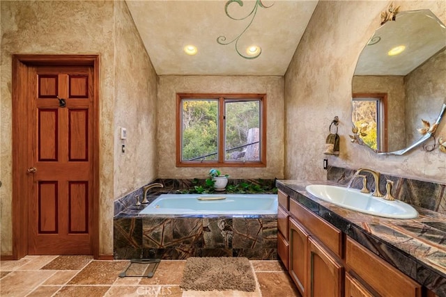 2743 Rodman Dr, Los Osos, CA 93402 - full bathroom with vanity, stone tile flooring, a bath, and recessed lighting