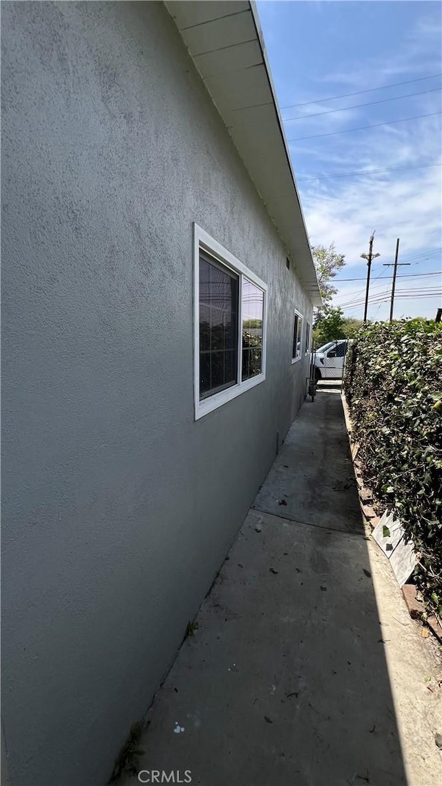 view of side of home with stucco siding