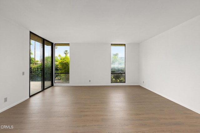 72460 Rodeo Way, Rancho Mirage, CA 92270 - spare room with wood finished floors, floor to ceiling windows, and baseboards