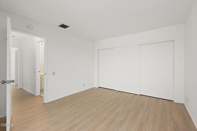 72460 Rodeo Way, Rancho Mirage, CA 92270 - unfurnished bedroom with light wood-style flooring, a closet, and baseboards
