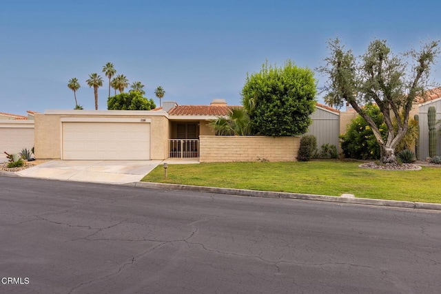72460 Rodeo Way, Rancho Mirage, CA 92270 - view of front of home featuring an attached garage, concrete driveway, and stucco siding