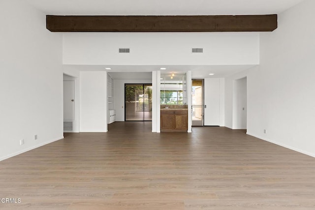 72460 Rodeo Way, Rancho Mirage, CA 92270 - unfurnished living room with beam ceiling, light wood-style floors, baseboards, and recessed lighting