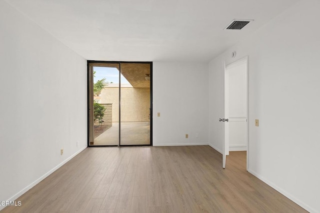 72460 Rodeo Way, Rancho Mirage, CA 92270 - spare room with a wall of windows, wood finished floors, and baseboards