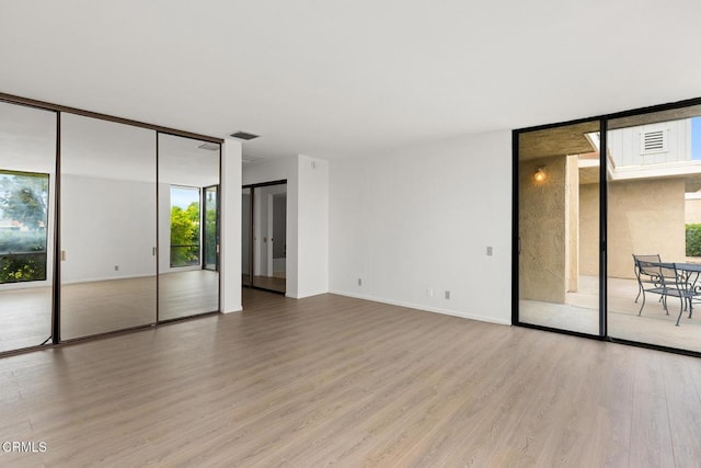 72460 Rodeo Way, Rancho Mirage, CA 92270 - empty room with expansive windows, wood finished floors, and baseboards