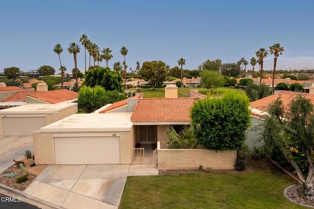 72460 Rodeo Way, Rancho Mirage, CA 92270 - view of front of house featuring stucco siding, a chimney, concrete driveway, a front lawn, and a garage