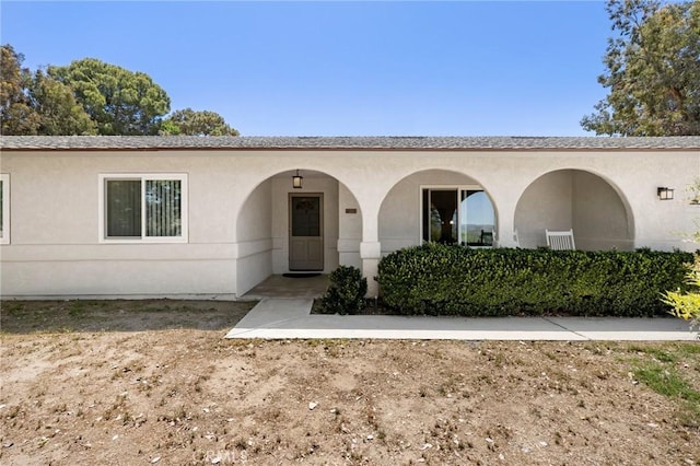 view of front of house featuring stucco siding
