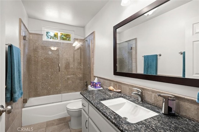 full bathroom featuring toilet, vanity, and bath / shower combo with glass door