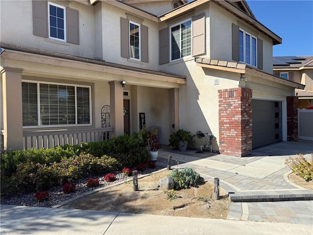36613 Wandering Pl, Murrieta, CA 92563 - view of front of house with an attached garage, covered porch, stucco siding, and driveway