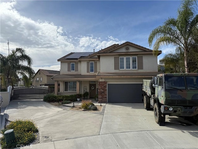 36613 Wandering Pl, Murrieta, CA 92563 - traditional-style home with a gate, stucco siding, driveway, an attached garage, and solar panels