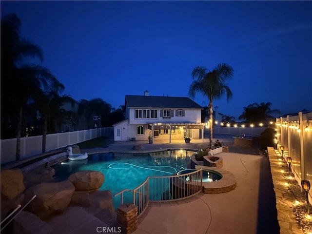36613 Wandering Pl, Murrieta, CA 92563 - pool at night with a fenced backyard, an outdoor kitchen, a patio area, and a pool with connected hot tub