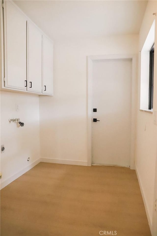 16109 Chuka Ave, Palmdale, CA 93591 - washroom with light wood-style flooring, cabinet space, baseboards, and washer hookup