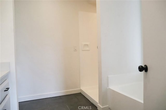 16109 Chuka Ave, Palmdale, CA 93591 - bathroom with tile patterned floors, a bath, vanity, and baseboards