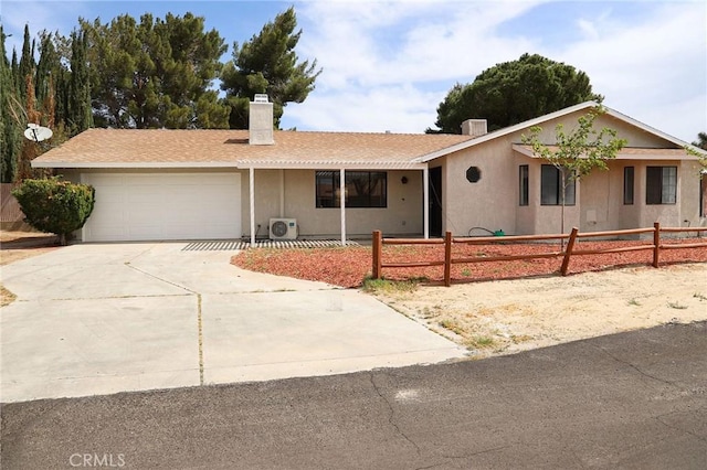 16109 Chuka Ave, Palmdale, CA 93591 - ranch-style house with an attached garage, a chimney, driveway, a cooling unit, and stucco siding