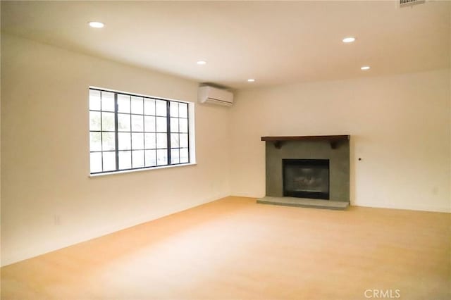 16109 Chuka Ave, Palmdale, CA 93591 - unfurnished living room featuring an AC wall unit, recessed lighting, and a glass covered fireplace