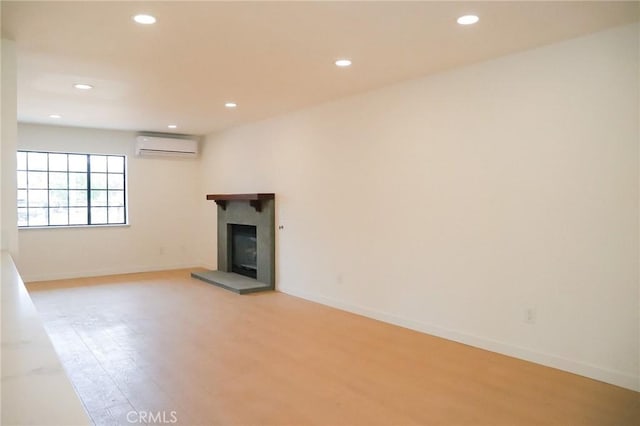 16109 Chuka Ave, Palmdale, CA 93591 - unfurnished living room featuring recessed lighting, light wood-style flooring, a tile fireplace, baseboards, and a wall mounted air conditioner