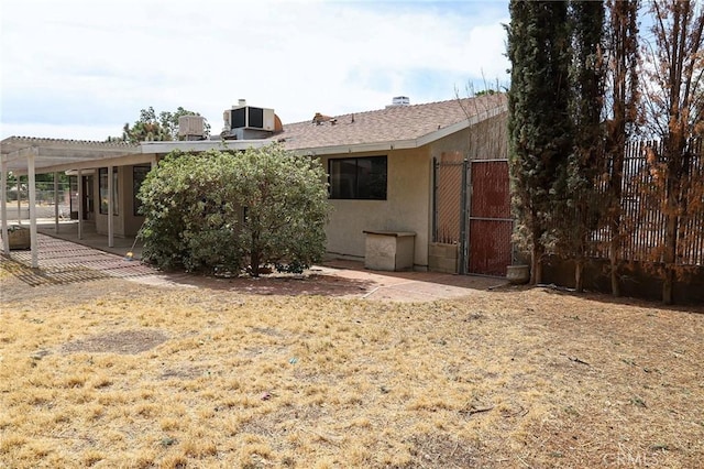 16109 Chuka Ave, Palmdale, CA 93591 - rear view of house with a pergola, fence, stucco siding, and a gate