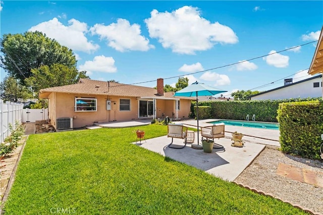 18633 Gledhill St, Northridge, CA 91324 - back of house featuring stucco siding, a patio, a chimney, a fenced backyard, and roof with shingles