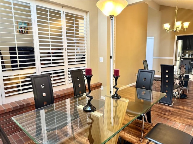 25453 Via Novia, Valencia, CA 91355 - dining space with a chandelier, vaulted ceiling, a desk, baseboards, and brick patterned floors