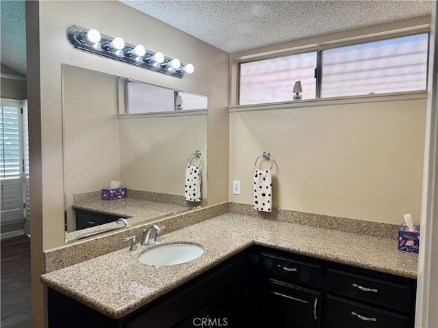 25453 Via Novia, Valencia, CA 91355 - bathroom with a textured ceiling, healthy amount of natural light, vanity, and wood finished floors