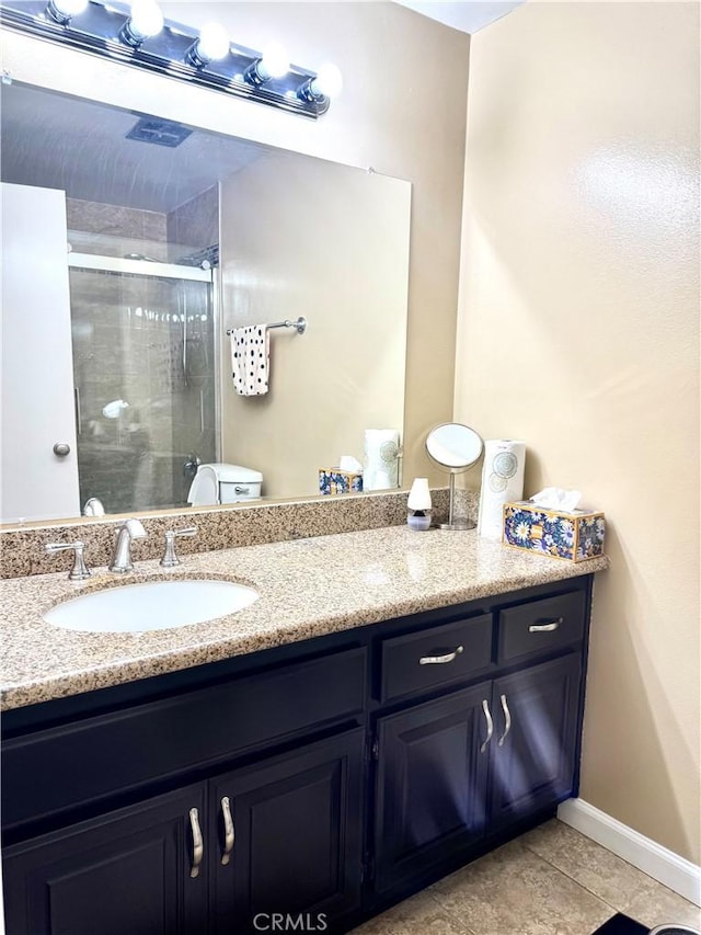 25453 Via Novia, Valencia, CA 91355 - bathroom featuring a shower stall, baseboards, vanity, toilet, and tile patterned flooring