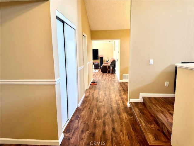 25453 Via Novia, Valencia, CA 91355 - hallway with dark wood-type flooring, lofted ceiling, and baseboards