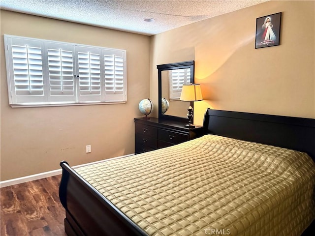 25453 Via Novia, Valencia, CA 91355 - bedroom featuring dark wood-style floors, a textured ceiling, and baseboards