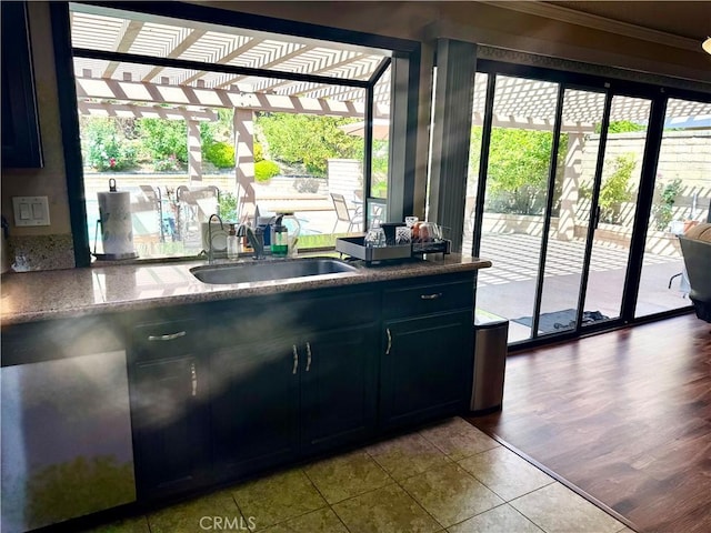 25453 Via Novia, Valencia, CA 91355 - kitchen with a sink, tile patterned floors, dark cabinetry, and ornamental molding