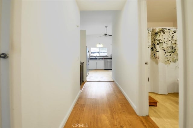13142 Reedley St, Arleta, CA 91331 - corridor featuring light wood-type flooring and baseboards