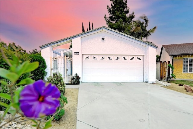 13142 Reedley St, Arleta, CA 91331 - view of front of home featuring stucco siding, driveway, and a garage