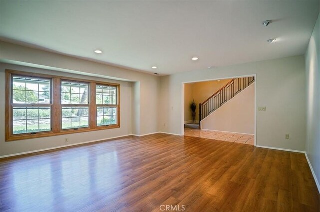 2521 Wildrose Ln, Upland, CA 91784 - spare room with wood finished floors, stairway, and recessed lighting